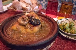 Bowl with chicken and dried fruit in sauce