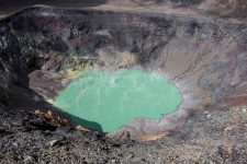 Turquoise lake with steam surrounded by rocks and dirt at Santa Ana Volcano El Salvador