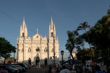 White, gothic cathedral at the end of a busy street in Santa Ana
