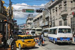 Buses and Taxis on a busy city street
