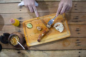Sausage being cut on a cutting board