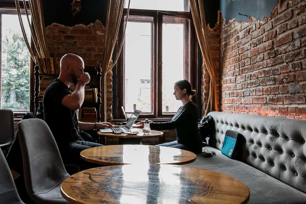 Two people sitting in a cafe using the fast internet in Romania