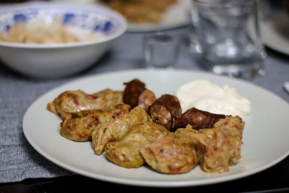 Cabbage rolls and sausages on a white plate