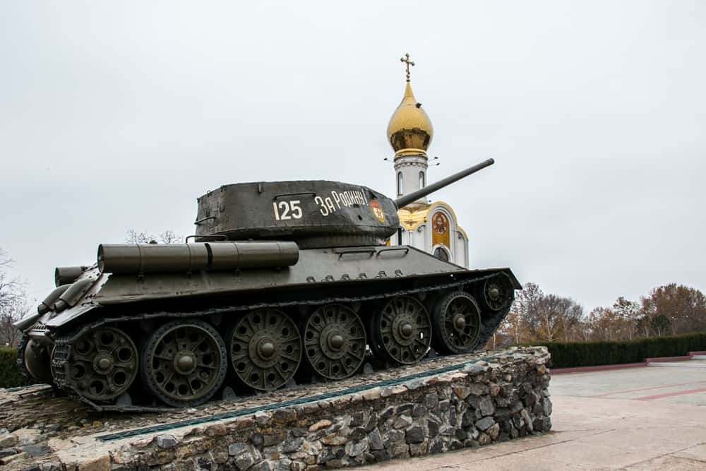 Soviet tank and a gold-topped church on a street