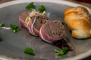 Plate of pate wrapped in bacon