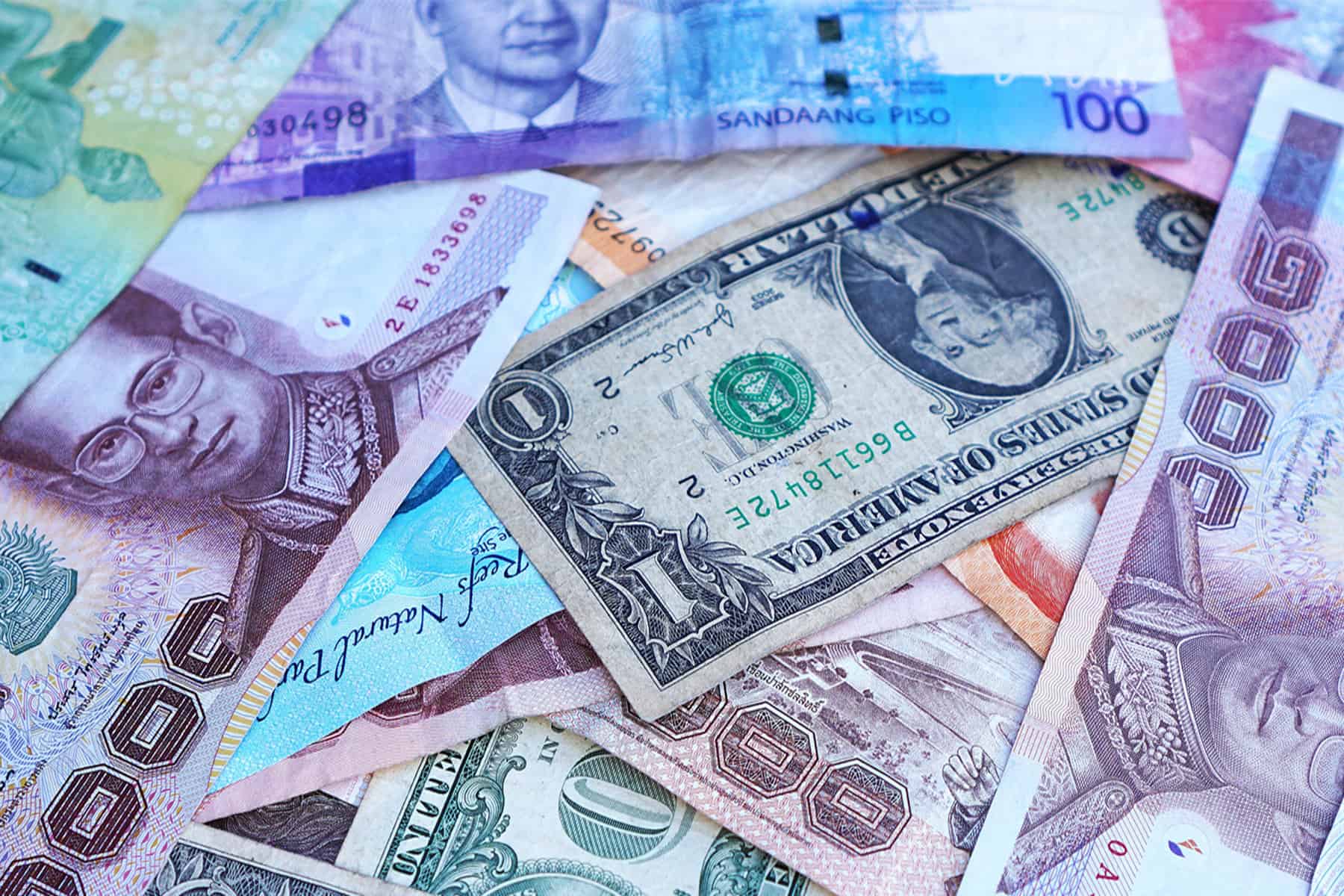 Banknotes of several currencies in a pile