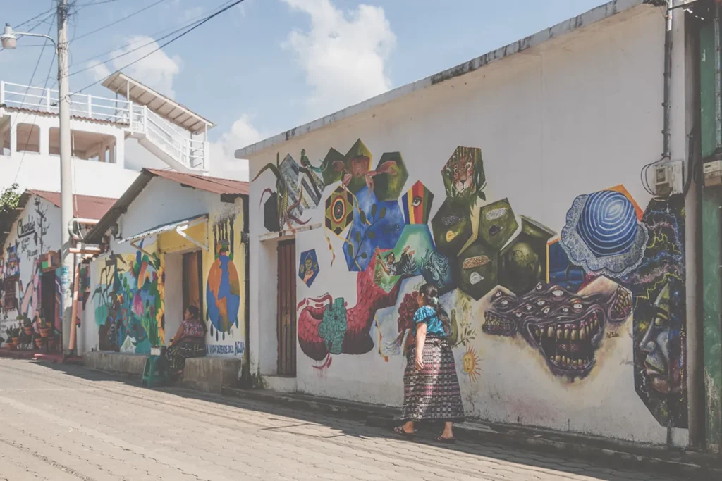 White walls covered in intricate patterned street art beside a chocolate shop in San Juan la Laguna, Lake Atitlan.
